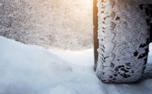 Close up of car tire on the snowy road with copy space