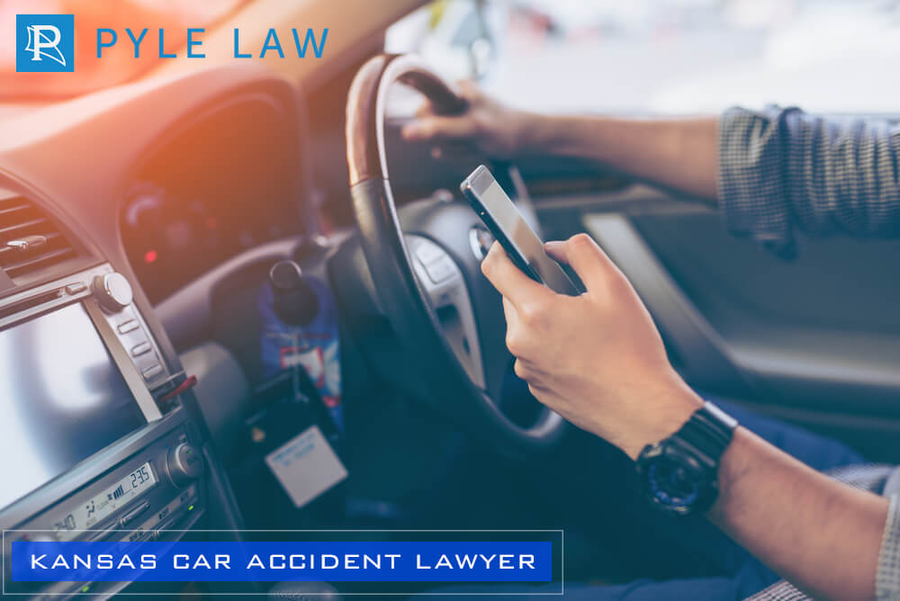 Hand's man using smartphone while driving the car - Pyle Law Kansas Car Accidents Lawyer