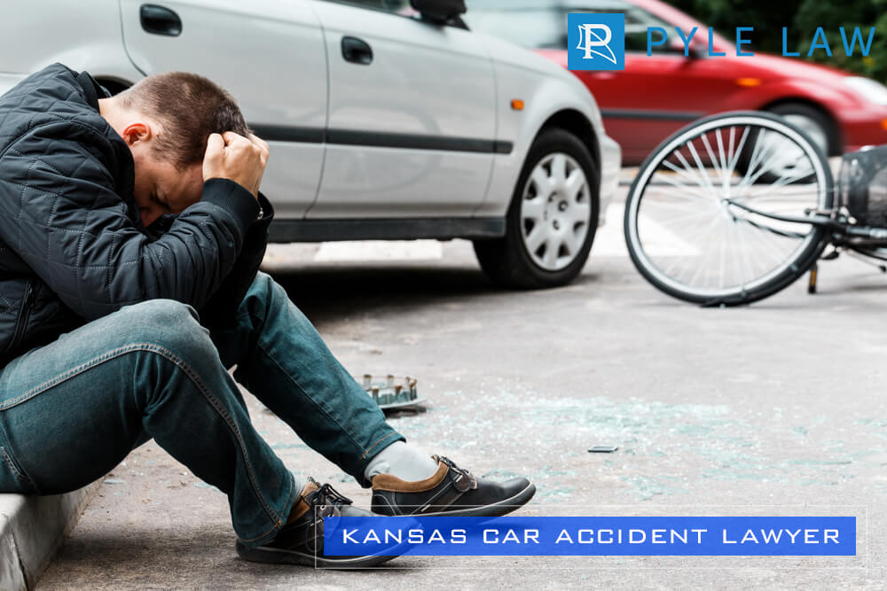 Man sitting on the sidewalk and crying after causing a car accident-Pyle Law Kansas Car Accident Lawyer
